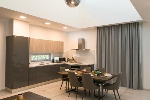 a kitchen and dining room with a table and chairs at Napa Hills Seaview Villas in Ayia Napa