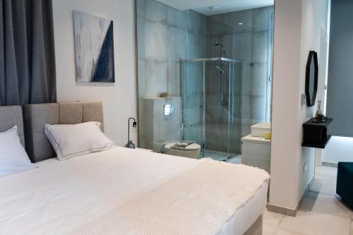 a bedroom with a large bed and a shower at Napa Hills Seaview Villas in Ayia Napa