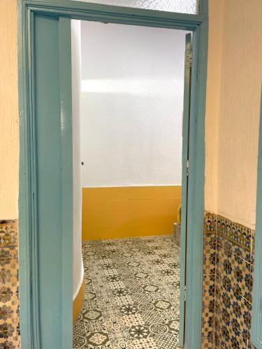 a door leading into a room with a tile floor at Riad chez brahim in Essaouira