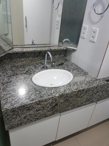 a bathroom counter with a sink and a mirror at hotel gold beach in Recife