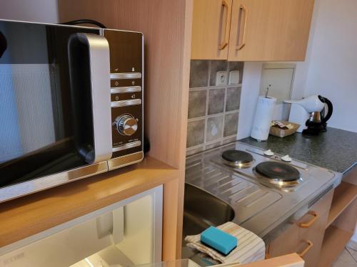 a small kitchen with a microwave and a counter top at Penzion Kostelany in Kostelany