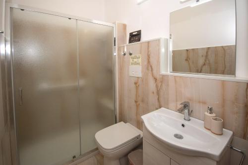 a bathroom with a toilet and a sink and a shower at Diegohousesleepaway in Vittoria