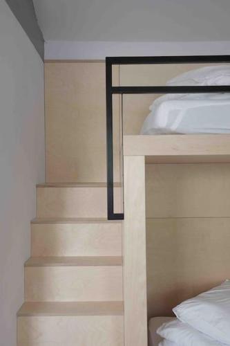 a bedroom with a bunk bed and a staircase at Blackett Street Bunkhouse in Leeds