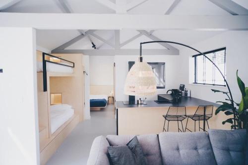 a living room with a couch and a kitchen at Blackett Street Bunkhouse in Leeds