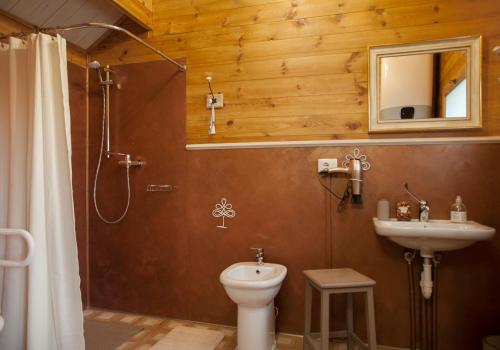 a bathroom with a toilet and a sink at Pian Del Mund in Borgomale