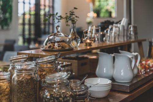 a table with jars and vases on it at The More Hotel Lund in Lund