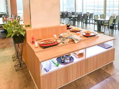 a restaurant with a buffet with food on it at LiVEMAX RESORT Sakurajima Sea Front in Tarumizu