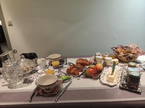 a table with a table cloth with food on it at Colette Alain Maxime in Lapalisse