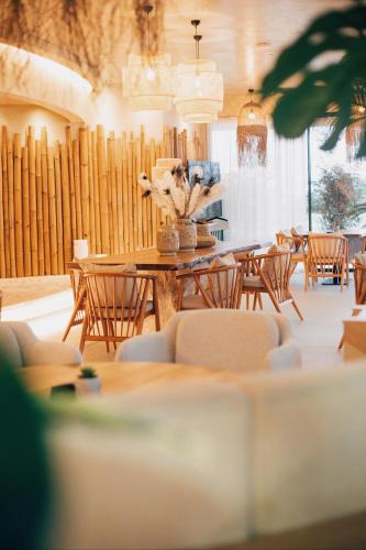 a dining room with a table and chairs at White Hill Hotel, SPA & Conferences in Durrës