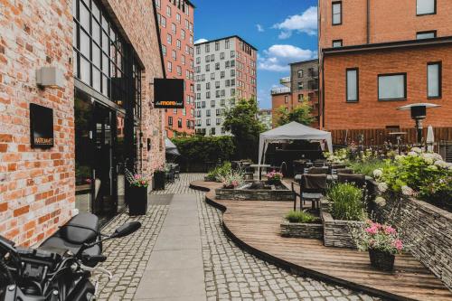 a sidewalk in a city with tables and a tent at The More Hotel Lund in Lund