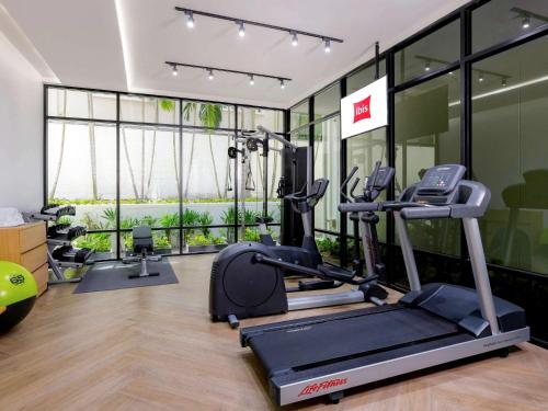 a gym with a treadmill and a elliptical machine at Hotel Ibis Samui Bophut in Bophut