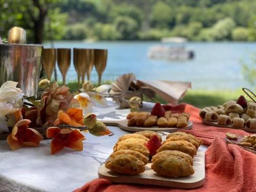 a table topped with plates of food on top of a table at AQUADOURO Yacht RADAMES - Sleep Boat Experience in Castelo de Paiva