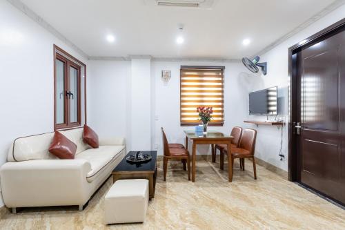 a living room with a couch and a table at CHÉRIE HOMEHOTEL in Ha Long