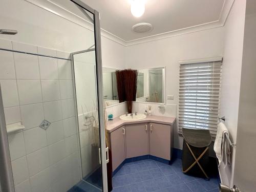 a bathroom with a sink and a shower at Beachside Townhouse Bunbury in Bunbury