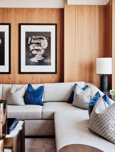 a living room with a couch with blue pillows at Grand Hyatt Kuwait in Kuwait
