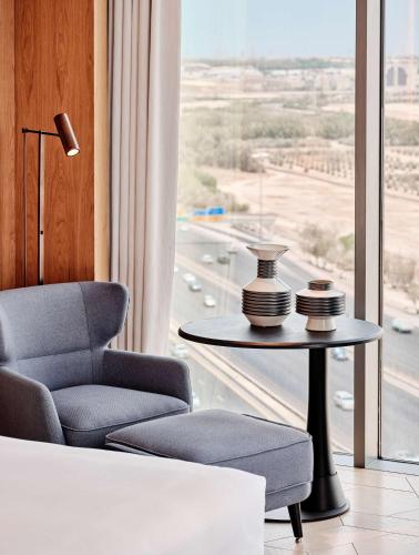 a room with a chair and a table and a window at Grand Hyatt Kuwait in Kuwait
