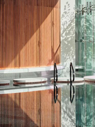 a reflection of a pool of water in a building at Grand Hyatt Kuwait in Kuwait