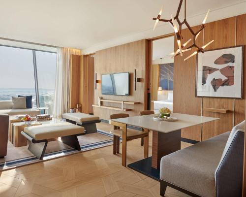 a living room with a couch and a dining room at Grand Hyatt Kuwait in Kuwait