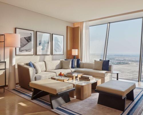 a living room with a couch and a table at Grand Hyatt Kuwait in Kuwait
