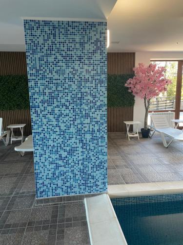 a blue tile wall next to a swimming pool at Complex Nero in Pamporovo