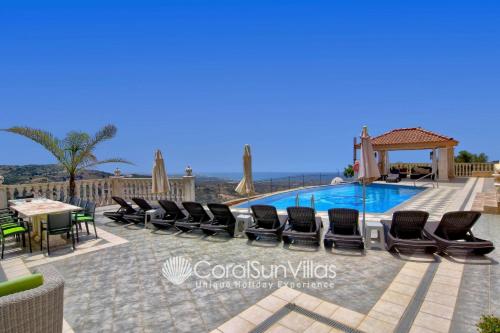 a villa with a pool and a table and chairs at Elegant Huge Villa Large Pool, Ideal For Weddings in Kathikas