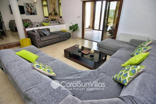 a living room with a couch and a table at Elegant Huge Villa Large Pool, Ideal For Weddings in Kathikas