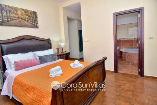 a bedroom with a bed and a bath tub at Elegant Huge Villa Large Pool, Ideal For Weddings in Kathikas