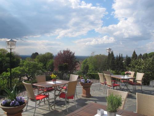 a group of tables and chairs on a patio at Käfernberg - Weinhotel in Alzenau in Unterfranken
