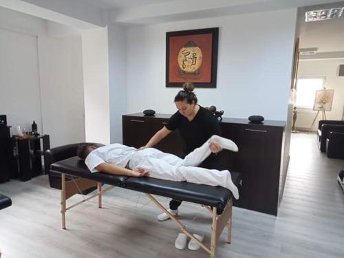 a man laying on a bed in a room at Casa Bella in Vadu Moţilor