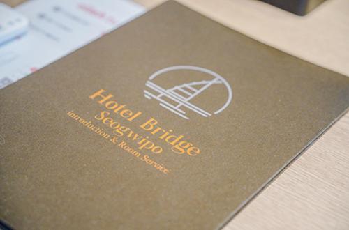 a passport with a picture of a camera on it at Hotel bridge Seogwipo in Seogwipo