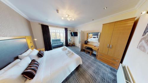 a hotel room with a bed and a desk at Marine Lodge in Great Yarmouth
