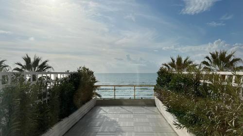 a walkway to the beach with the ocean in the background at Adriatik Hotel, BW Premier Collection in Durrës