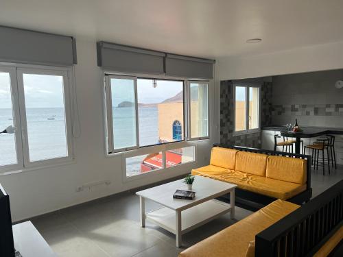 ein Wohnzimmer mit einem Sofa und einem Tisch in der Unterkunft Edificio Playa Chica in El Médano