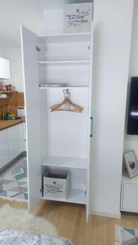 a white closet with a box in a kitchen at Pineta Apartman Bjelasnica in Bjelašnica