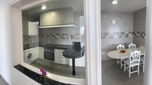 a kitchen with a table and a dining room at Edificio Playa Chica in El M&eacute;dano