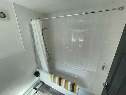 a bathroom with a shower and a white tub at Lovely Seaside House in Cleethorpes Beachfront Area sleeps up-to 6 in Cleethorpes