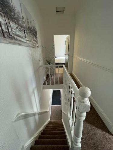 a staircase in a house with a stair case at Lovely Seaside House in Cleethorpes Beachfront Area sleeps up-to 6 in Cleethorpes