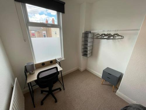 a room with a desk and a window and a chair at Lovely Seaside House in Cleethorpes Beachfront Area sleeps up-to 6 in Cleethorpes