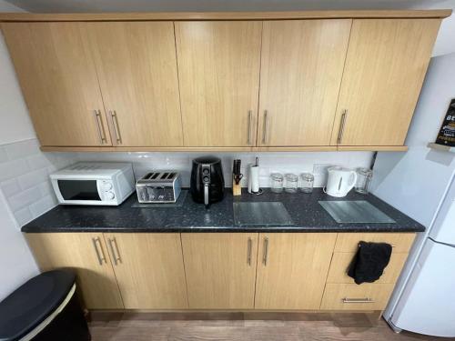 a kitchen with a counter top with a microwave at Lovely Seaside House in Cleethorpes Beachfront Area sleeps up-to 6 in Cleethorpes