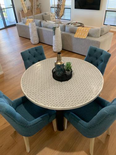 a white table and chairs in a living room at Forever Endeavour in Mission Beach