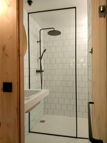a shower with a glass door next to a sink at Apartamento en Chueca Gran via con Smart TV in Madrid