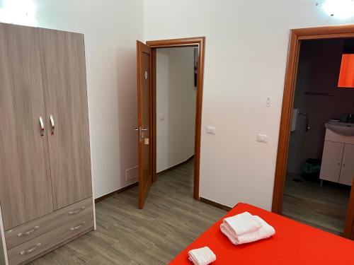 a bedroom with a mirror and a bed with red sheets at Appartamento Madame in Cosenza