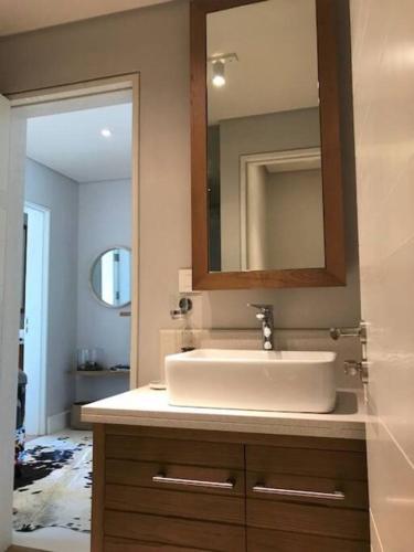 a bathroom with a sink and a mirror at Wozamoya in Rivière Noire