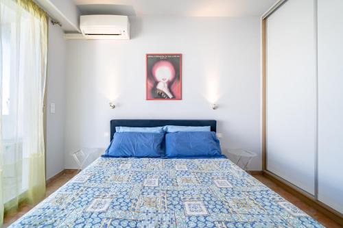 1 dormitorio con 1 cama con almohadas azules en Palm beach- Free Wifi- Parking- Sea View, en Cannes
