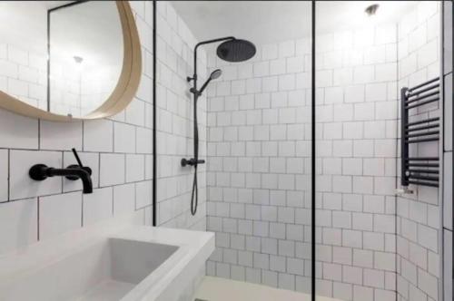 a bathroom with a shower and a sink and a mirror at Apartamento en Chueca Gran via con Smart TV in Madrid