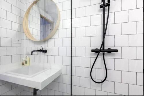 łazienka z prysznicem, umywalką i lustrem w obiekcie Chueca Downtown Studio w Madrycie
