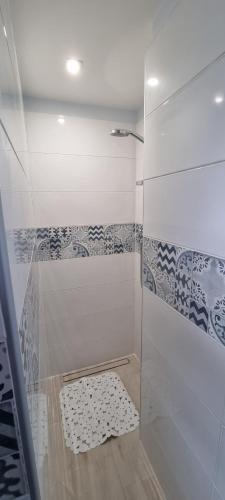 a shower with a glass door with a stool in it at Appartamento - Gaeta in Gaeta