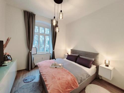 a bedroom with a large bed and a window at Daheim in Dresden in Dresden