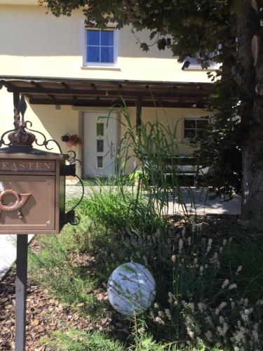 a sign in front of a house with a building at Apartmentvermietung Ingrid Bolkart - Vöhlino 2 in Illertissen