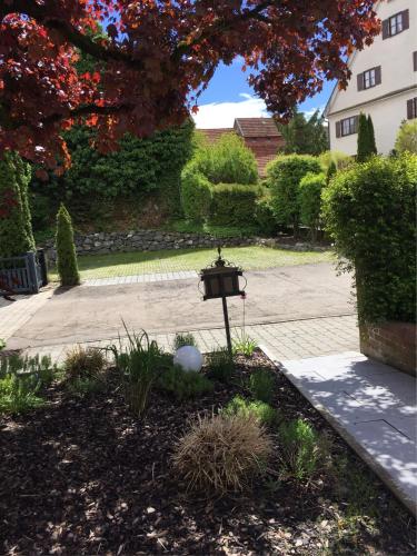 a garden with a lamp in the middle of a driveway at Apartmentvermietung Ingrid Bolkart - Vöhlino 2 in Illertissen